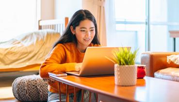 Young Asian girl on laptop
