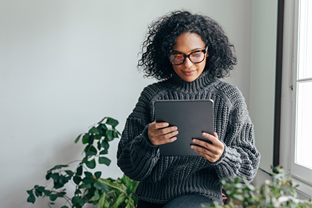 Inquisitive woman holding a tablet