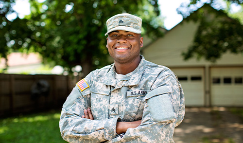 Military Man standing in front of home