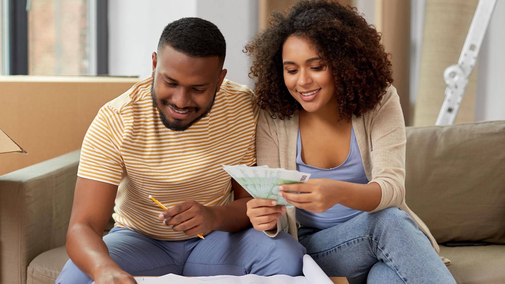 boy and girl on couch counting money