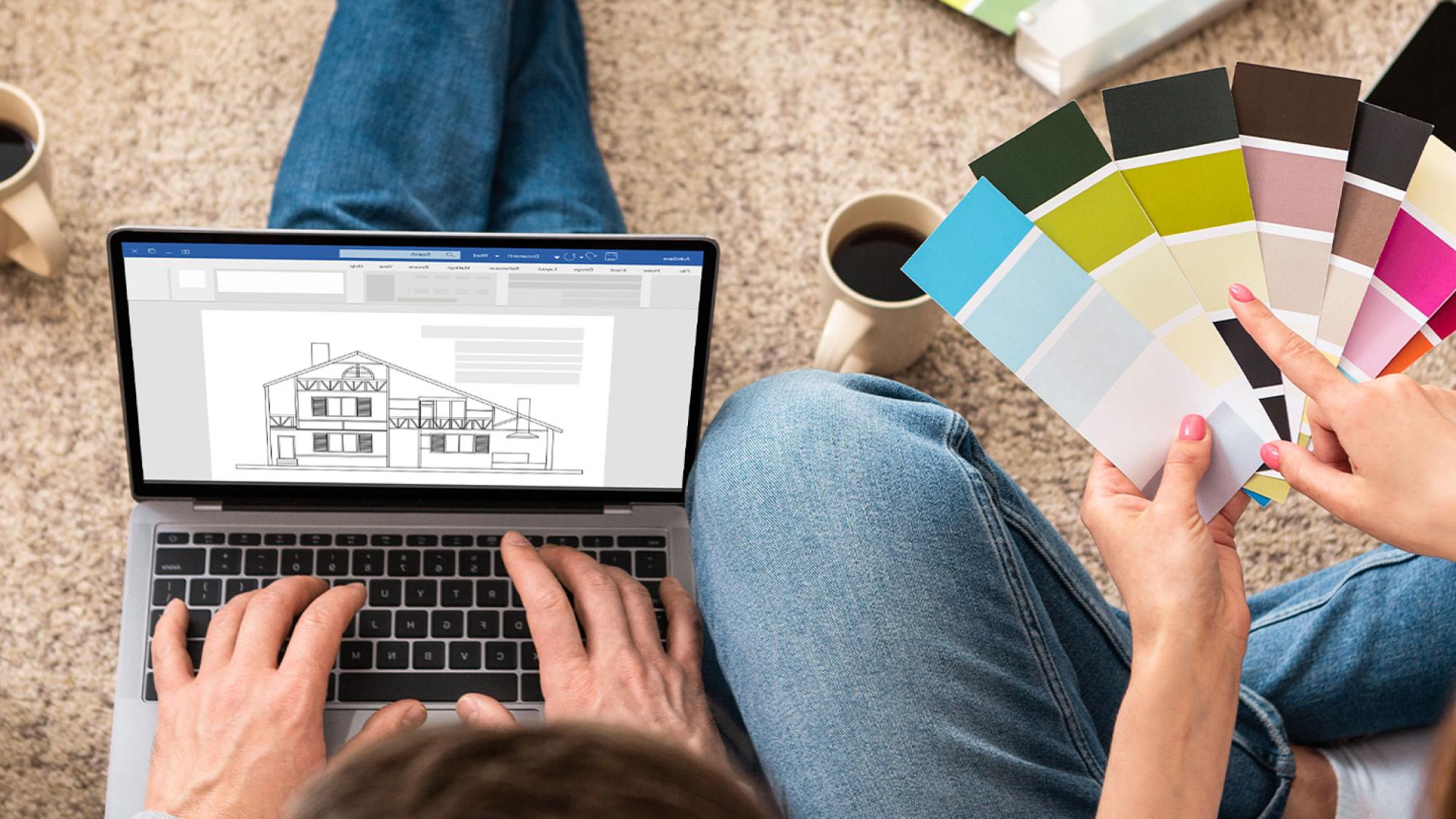 Two planning a house, looking at paint samples