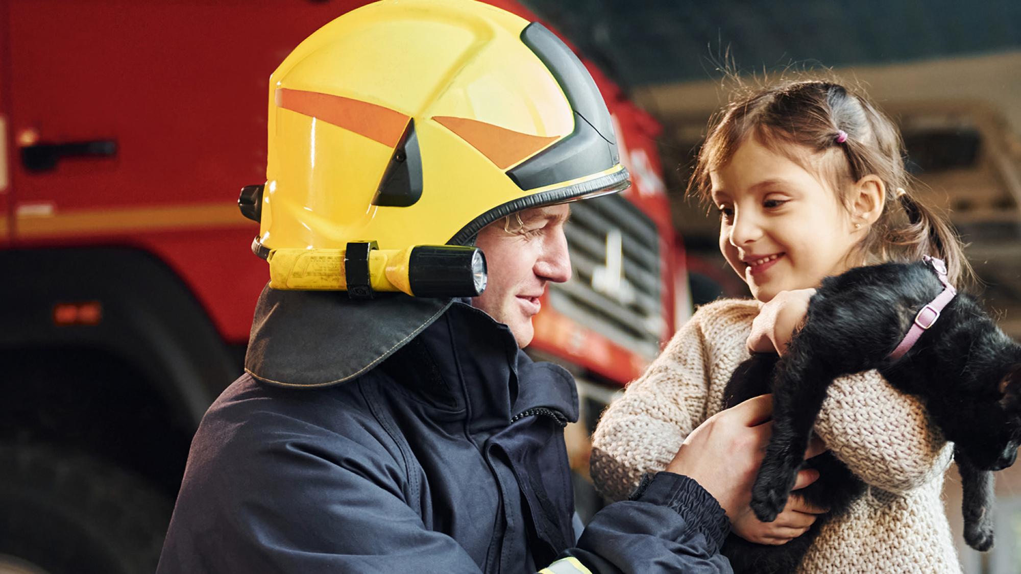 firefighter with child and kitten