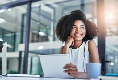 smiling woman in front of laptop