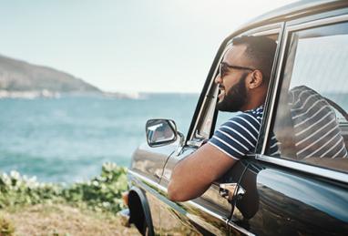 man in car overlooking beach, car loan