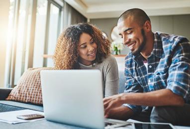 young African-American couple using laptop, paying bills online, managing finances, building credit, boosting credit score, how to build credit, how to improve credit score
