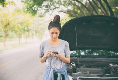 car broken down on side of road, young Asian woman using cellphone, emergency, emergency fund, emergency cash