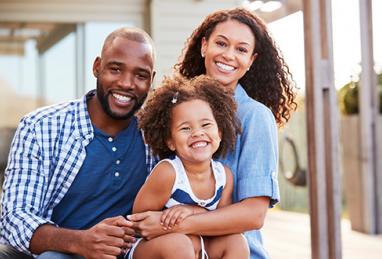 African-American family in front of home, happy family smiling, house, home, home loan, mortgage loan, different type of mortgage loans 