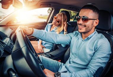 couple driving in car, happy couple smiling, sunny day, interracial couple, car, car loan, auto loan, refinance 
