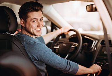 handsome young man taking used car for test drive, used car shopping, buying a used car