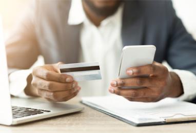 close-up of black business man holding credit card and smartphone, credit card, balance transfer, benefits of balance transfers 