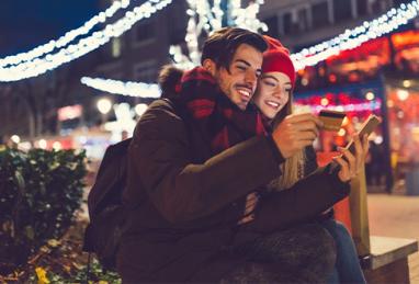 young white couple holding credit card and smartphone, traveling, holiday travel, credit card, credit card rewards