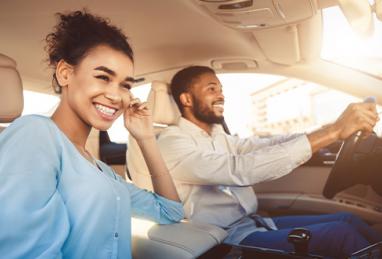 young black couple smiling and driving in car, auto loan, auto loan refinance, refinance your auto loan, refinance and save