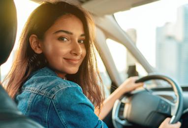 young Indian woman driving car, buying a car, buying your first car, car buying, test drive, auto loan