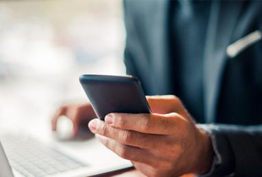 closeup of man holding smartphone in one hand, multitasking, cybersecurity, digital banking, online account, username, user ID, password, login credentials, protecting yourself online