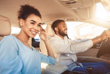 young black man and woman driving in car, young couple in car