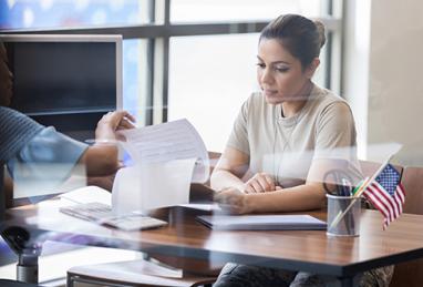 young female soldier reviewing loan paperwork with banker, explaining amortization, bank, credit union, loan officer, member, loan application, amortization