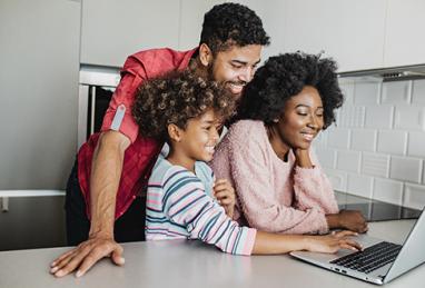 black parents and child using laptop while standing in kitchen, looking up information online, child tax credit 