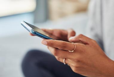 closeup of young woman holding smartphone in her hands, social media, social media scams, cybersecurity 