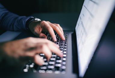close up of hands typing on a laptop, cryptocurrency, cryptocurrency scams, scams, fraud