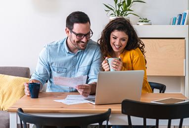 young adult white couple reviewing finances on laptop, reviewing finances, reviewing savings