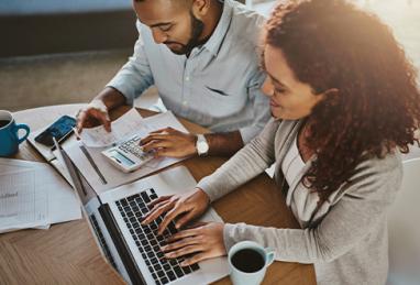 high angle shot of young couple planning their budget together at home 