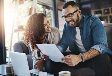 young mixed-race couple planning their finances together at home 