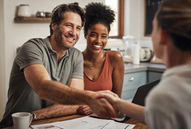 interracial couple submitting an offer an a home, shaking hands, buying a home 