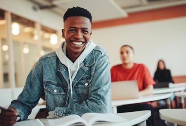 black college student smiling while sitting in classroom