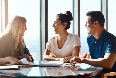 young Hispanic couple meeting with a member service representative in an office at a credit union 