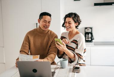 online banking for family budget - couple in the kitchen with bills