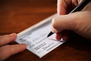 Writing a donation check to a charitable organization