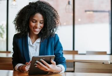 black businesswoman in an office using digital tablet