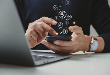 person holding smartphone in hands, coin icons floating above phone, online transaction, digital banking, cryptocurrency, financial technologies, fintech
