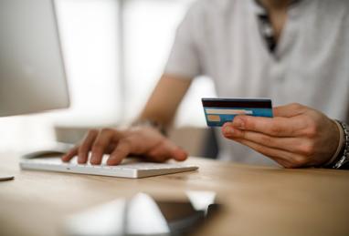 man using his credit card to make an online payment