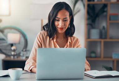 Woman working on laptop online, creating budget plan online