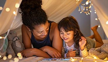 Mother and daughter smiling with tablet