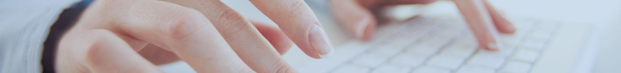 hands typing on keyboard