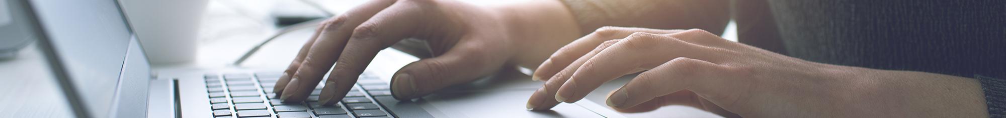 Hands typing on keyboard